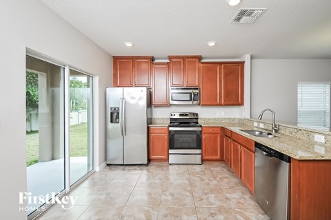a kitchen with wooden cabinets and stainless steel appliances