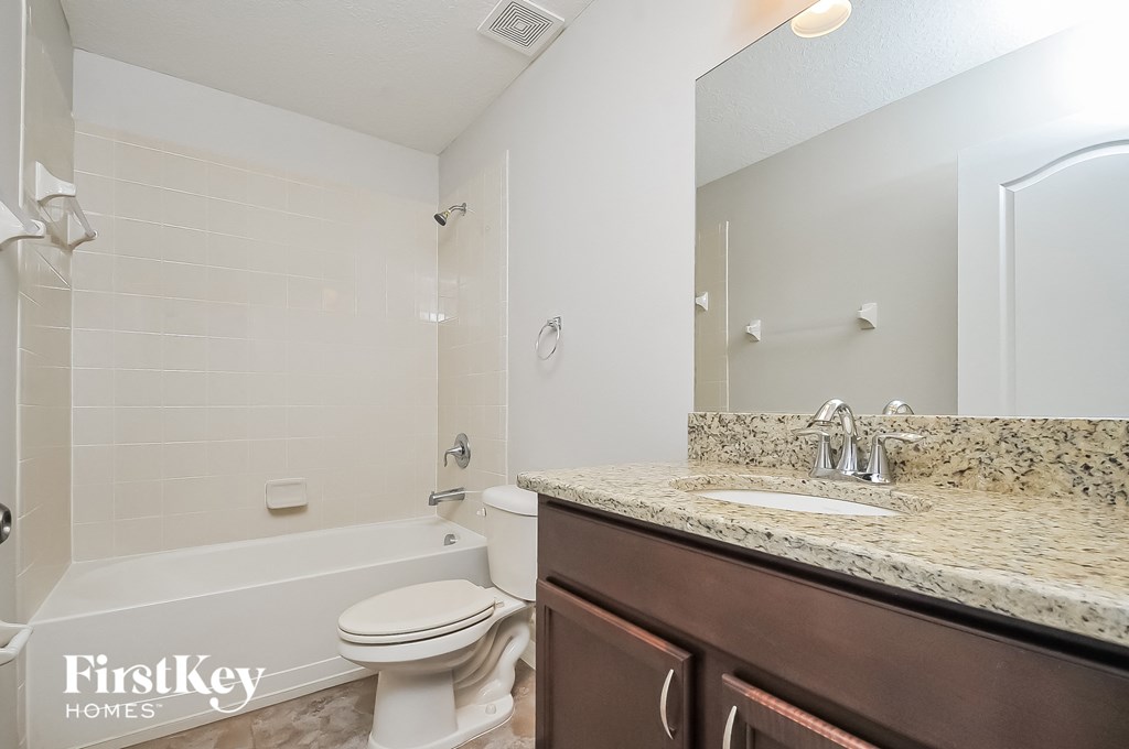 a bathroom with a sink and a toilet and a bath tub
