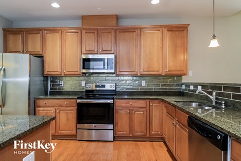 a kitchen with wooden cabinets and stainless steel appliances