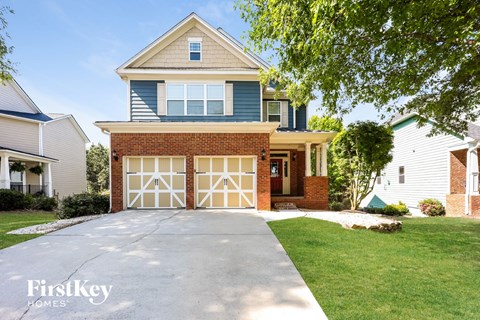 A two-story house with a garage is for sale.