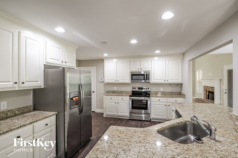 A kitchen with granite countertops and stainless steel appliances.