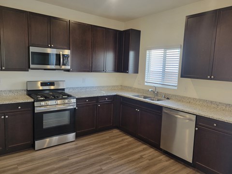 a kitchen with granite counter tops and stainless steel appliances