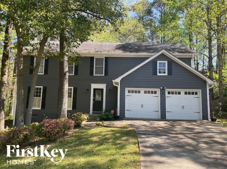 a gray house with a white garage door