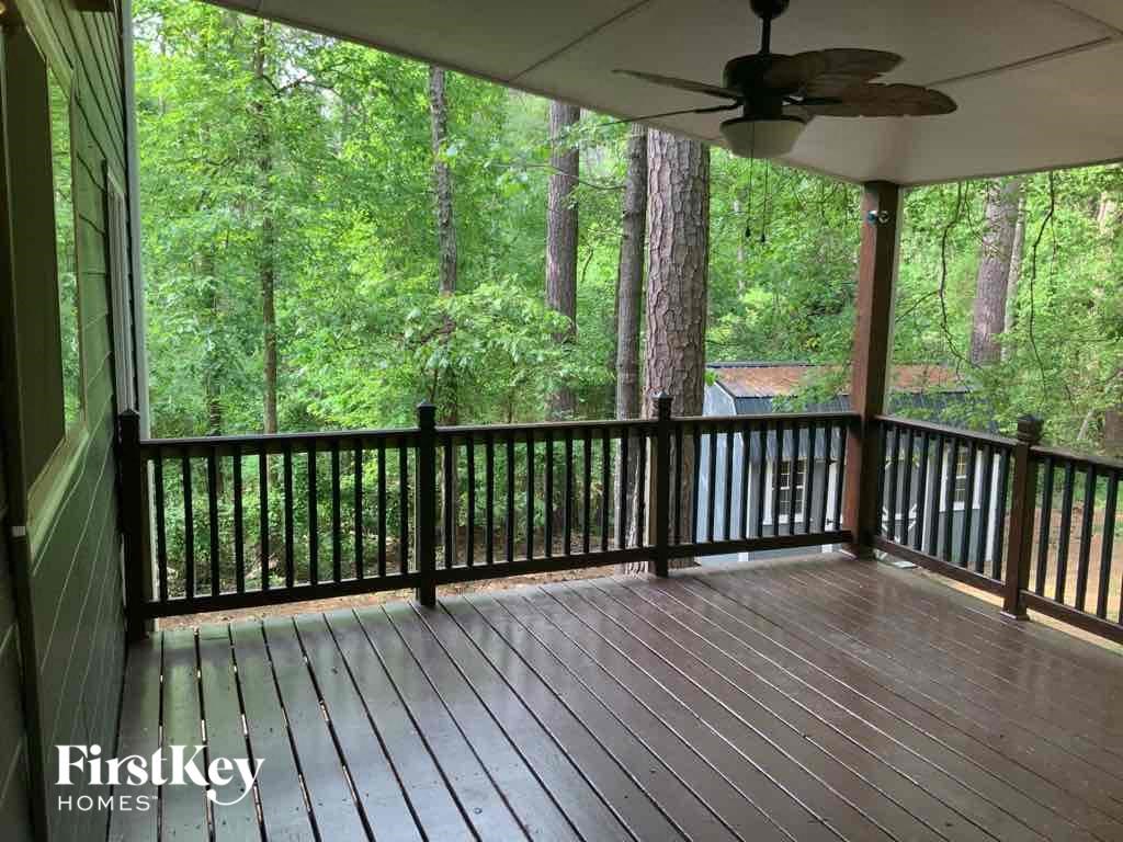 the porch of a cabin with a view of the woods