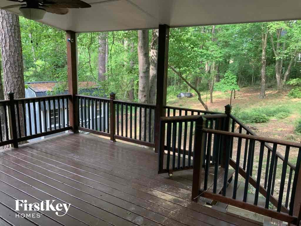 a covered porch with a view of the woods