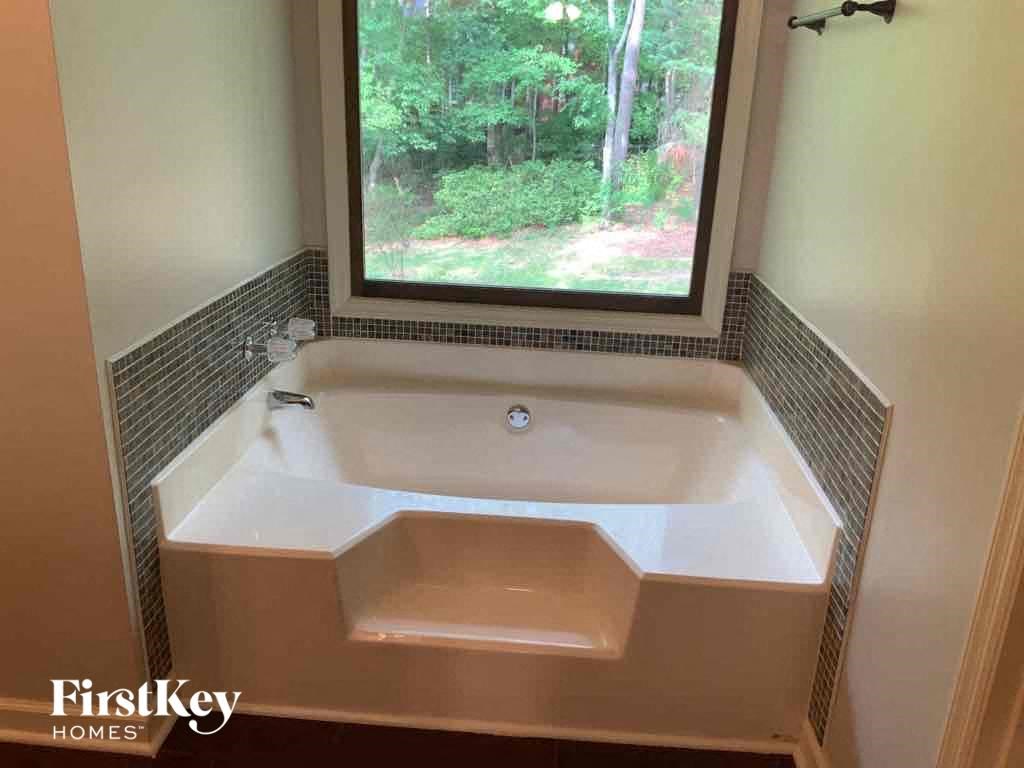 a bath tub in a bathroom with a window