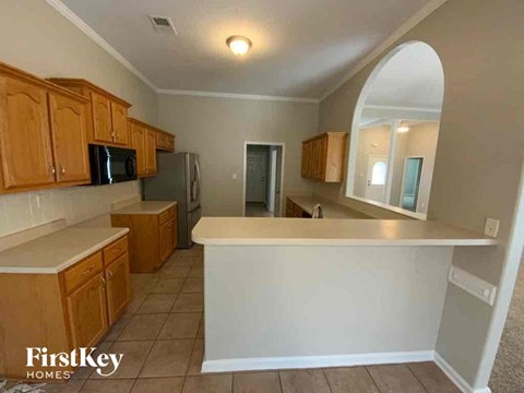 A kitchen with wooden cabinets and a white countertop.