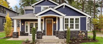 a house with blue siding and a wooden door