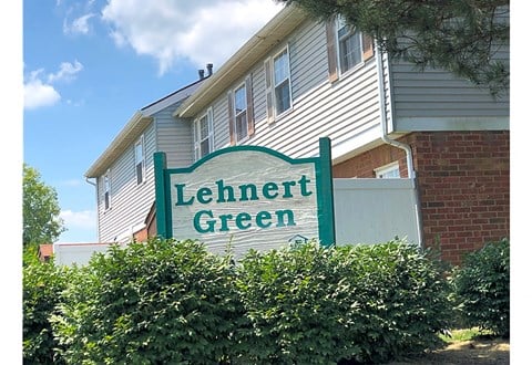 the exterior of a building with a green sign that reads lehner green
