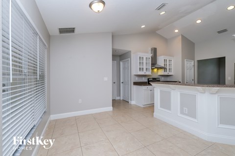 A kitchen with white cabinets and a countertop.