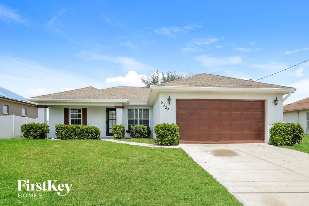 A house with a brown garage door is for sale.