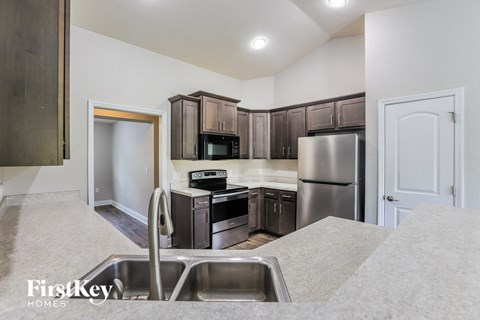 a kitchen with stainless steel appliances and wooden cabinets
