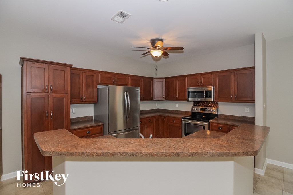 a kitchen with wooden cabinets and a granite counter top