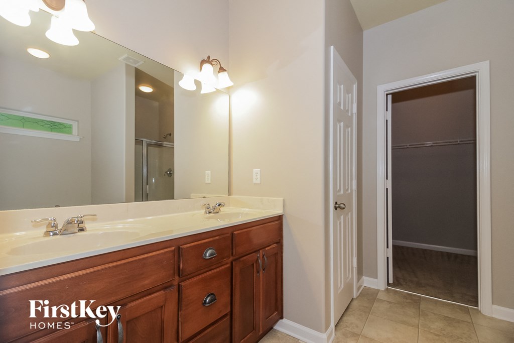 a bathroom with a sink and a mirror and a shower
