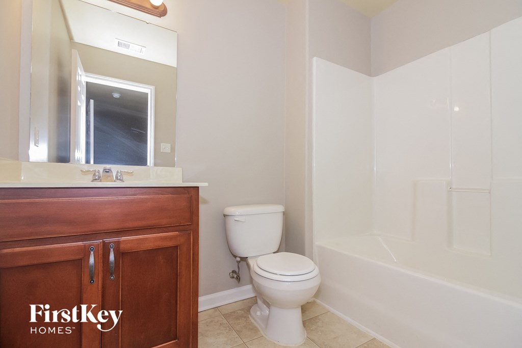 a bathroom with a toilet and a sink and a bath tub
