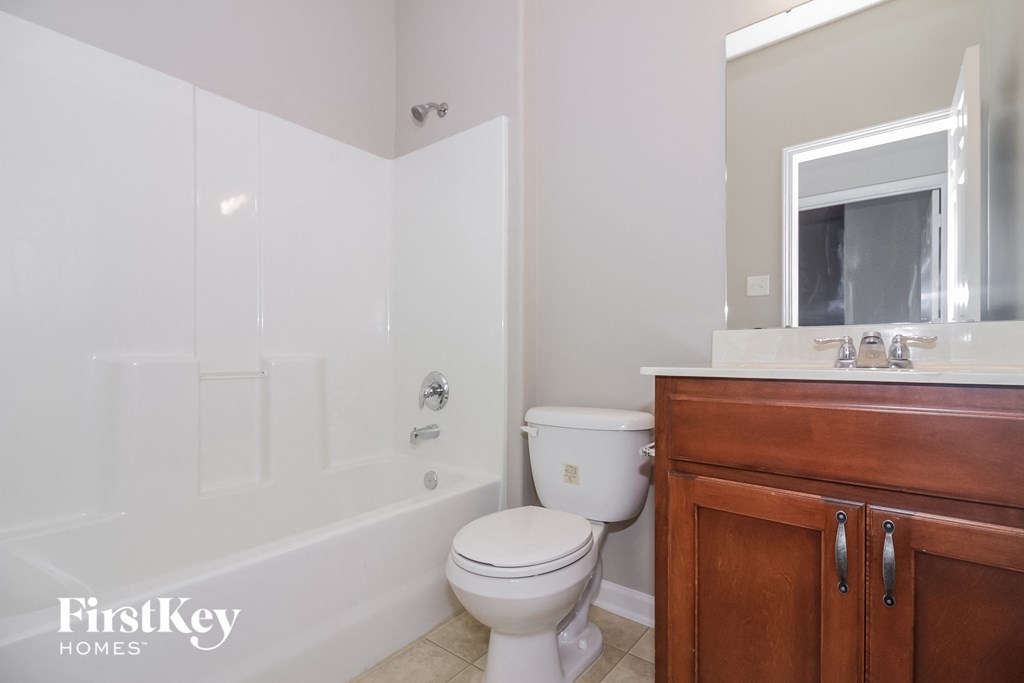 a bathroom with a toilet and a tub and a sink
