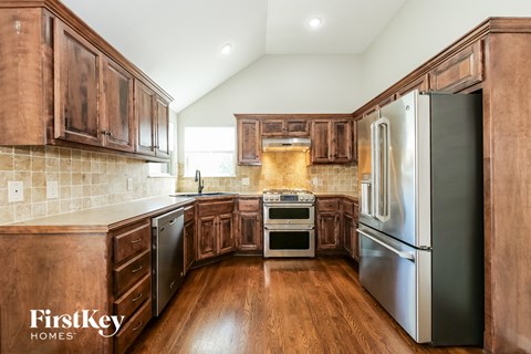 A kitchen with wooden cabinets and stainless steel appliances.
