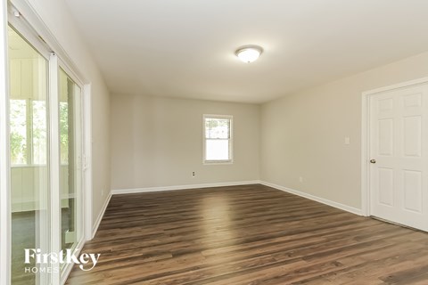 A room with wooden floors and a window.