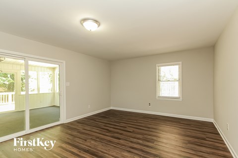A room with wooden floors and a window.