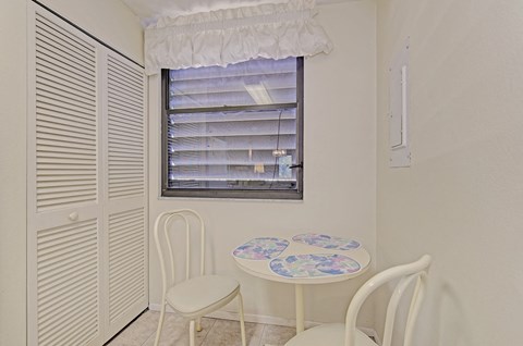a dining room with a table and chairs and a window