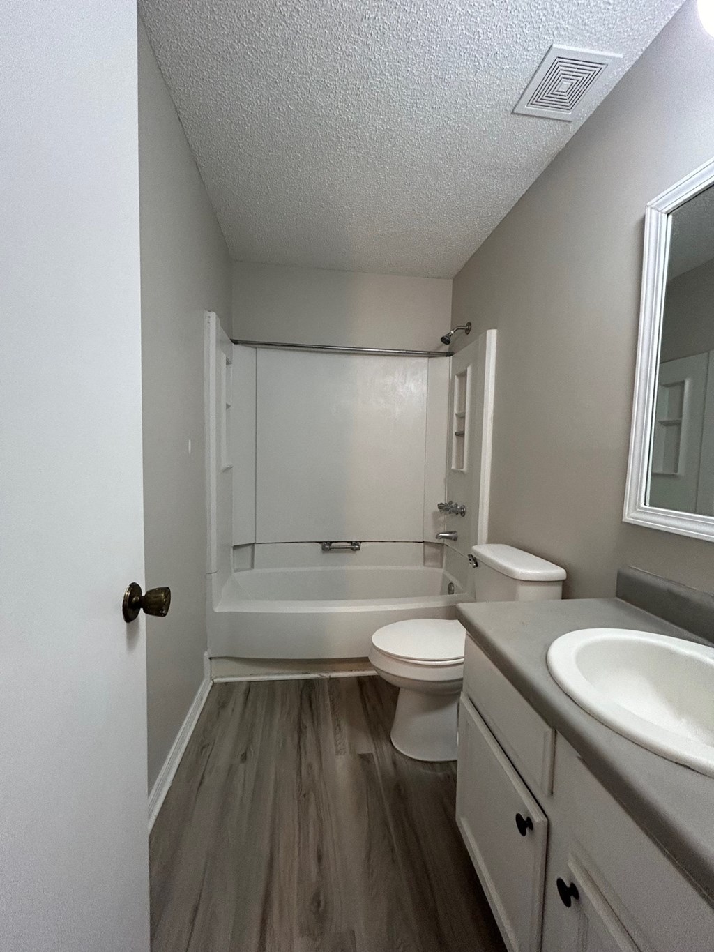 A bathroom with a toilet, sink, and bathtub.
