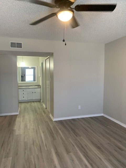 A room with a ceiling fan and light fixture.