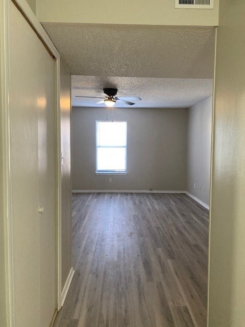 A room with a window and a ceiling fan.