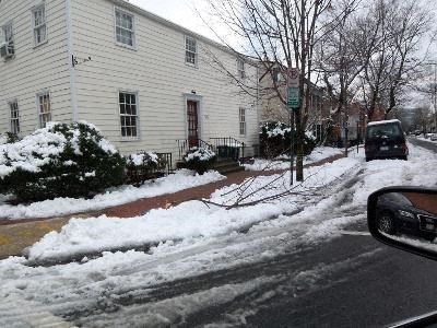 A car is parked on a snowy street.