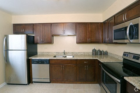 a kitchen with stainless steel appliances and wooden cabinets