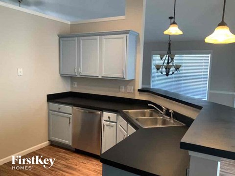 A kitchen with a stainless steel dishwasher and a sink.