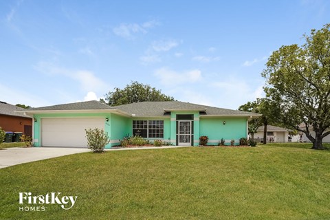 a green house with a lawn in front of it