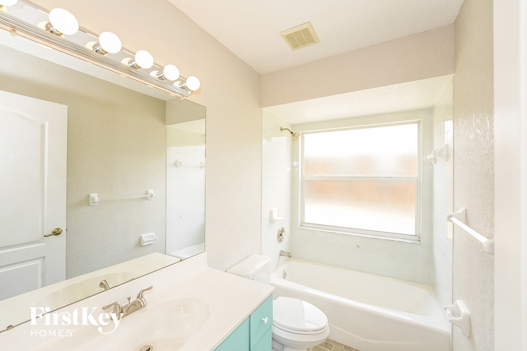 a bathroom with a sink and a toilet and a tub