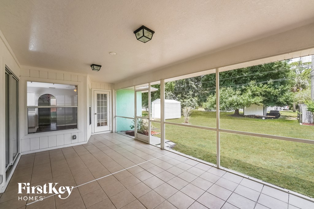 a view of the patio from the living room of a home with large windows