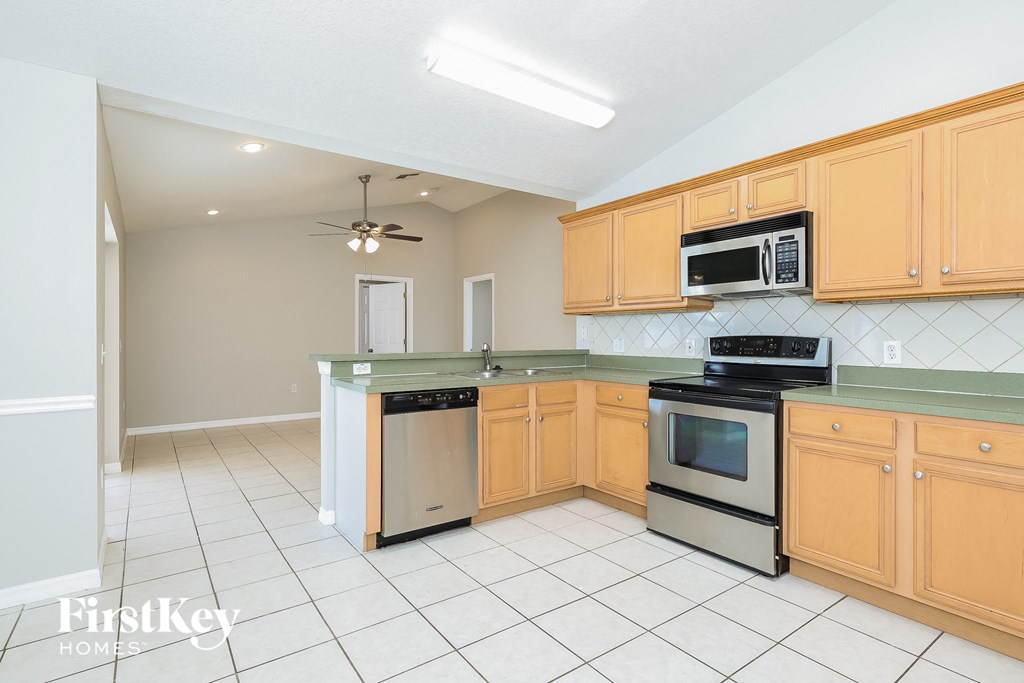 a kitchen with wooden cabinets and stainless steel appliances