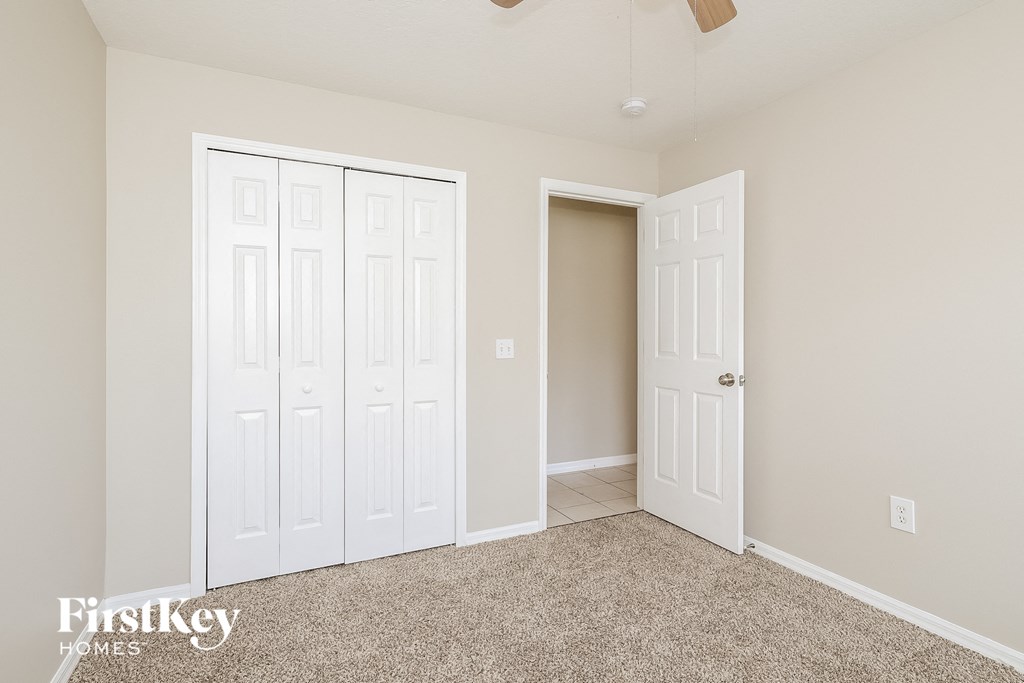 a bedroom with two closets and a door to a closet