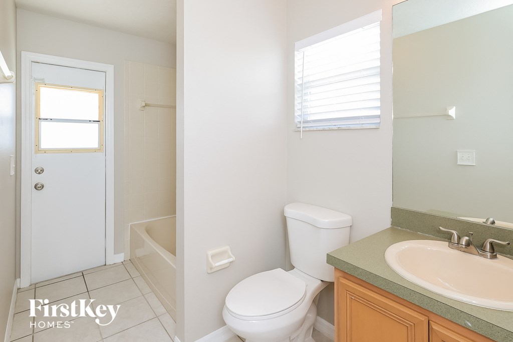 a bathroom with a toilet and a sink and a shower