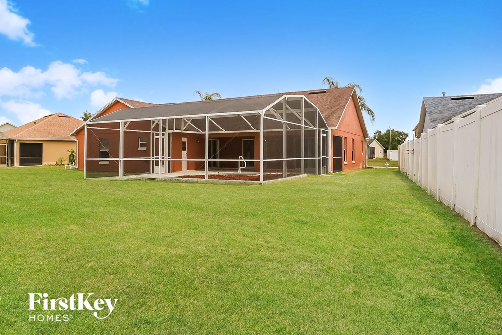 a conservatory with a lawn in front of a house