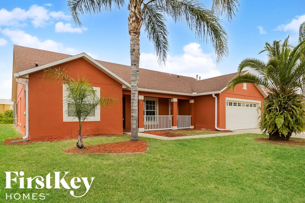 a house with palm trees in front of it