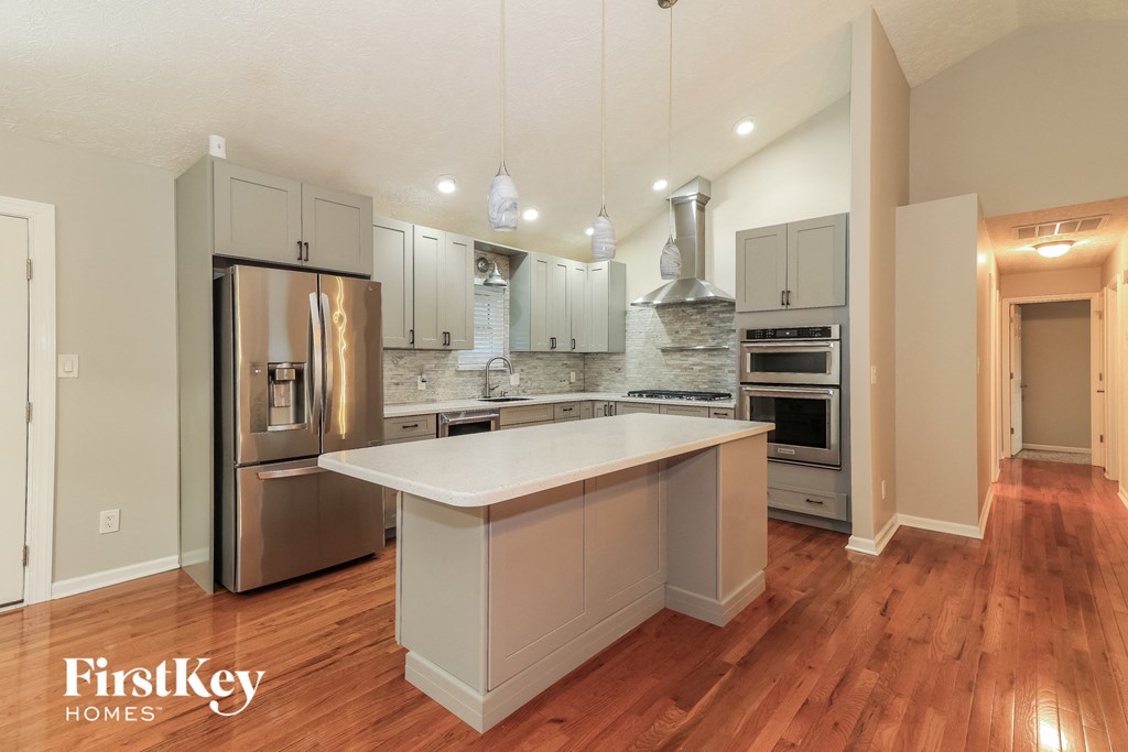 a kitchen with stainless steel appliances and a white counter top