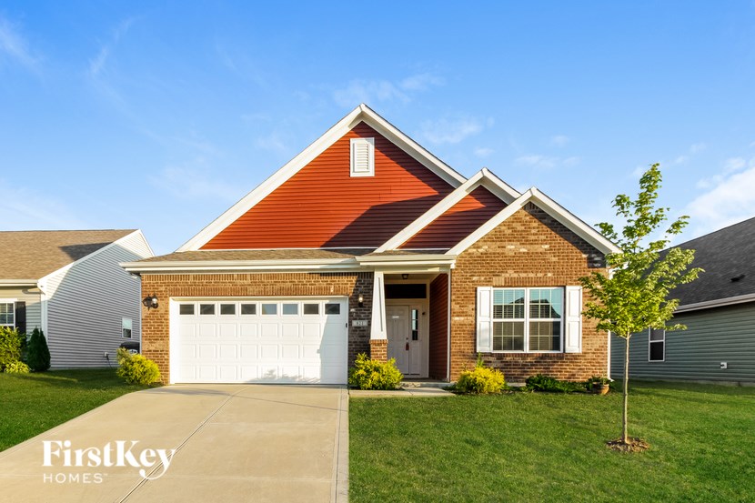 A house with a red roof and a white garage door.