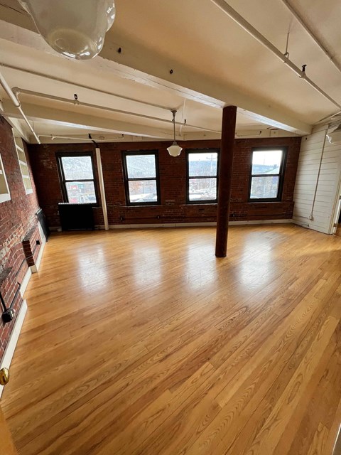 A room with wooden floors and white walls.