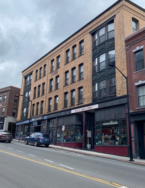 A street view of a building with a sign that reads "Estate Uses & Hire".