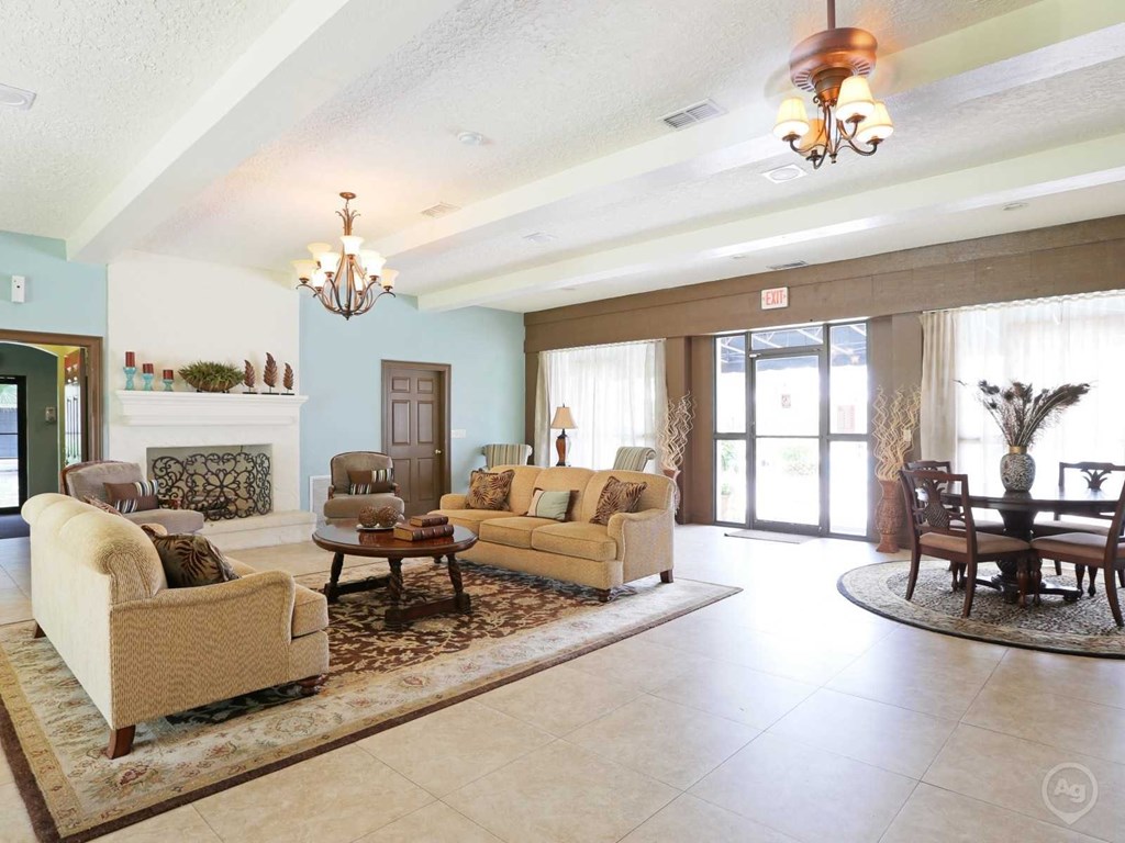 A living room with a fireplace and a chandelier.