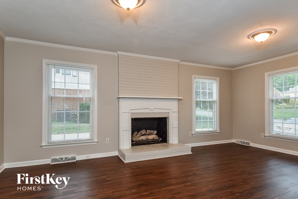 a living room with a fireplace and a wooden floor