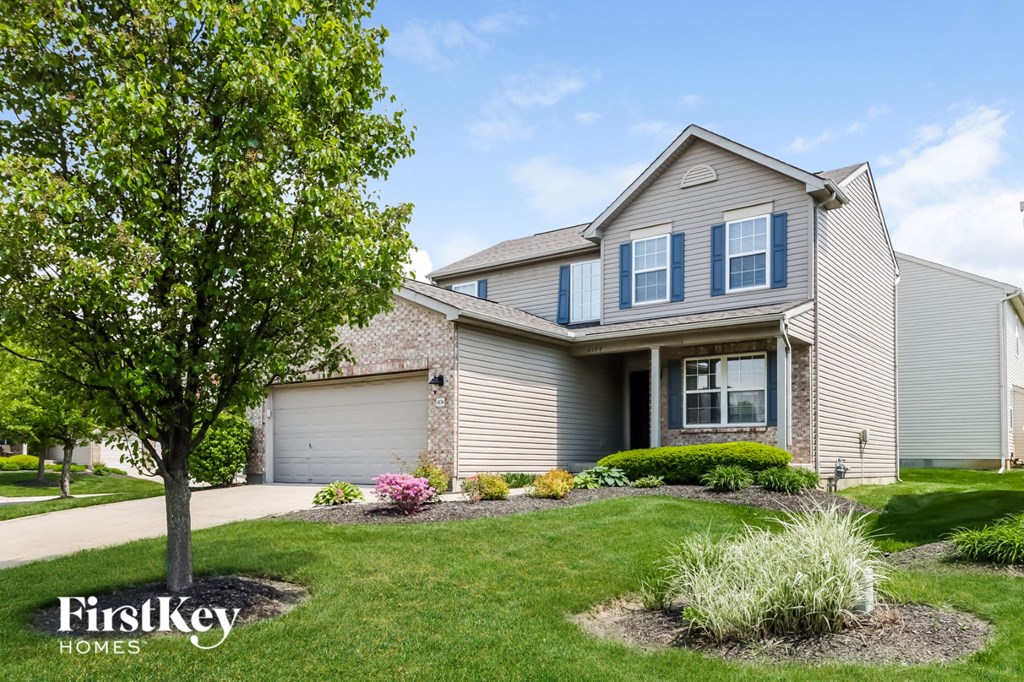 A house with a tree in front of it.