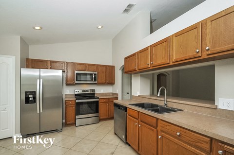 a kitchen with stainless steel appliances and wooden cabinets