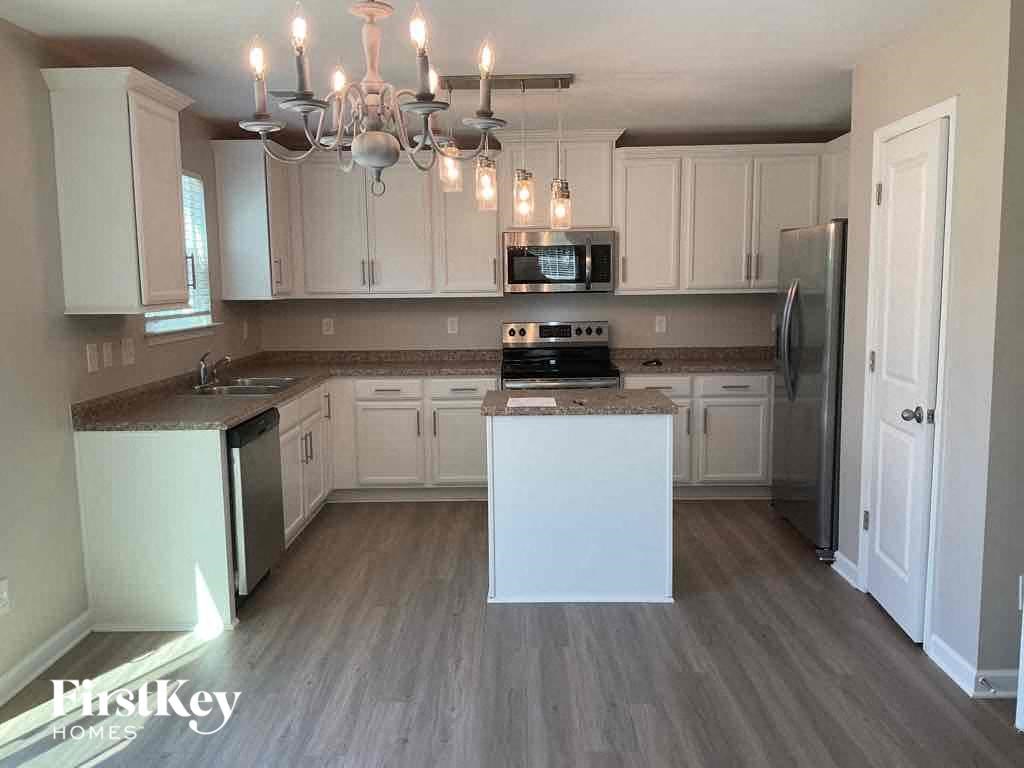 a kitchen with white cabinets and a counter top