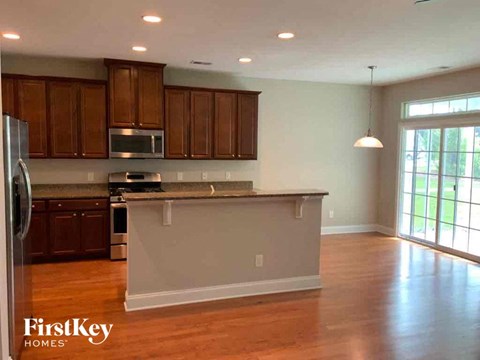 A kitchen with wooden cabinets and a refrigerator.