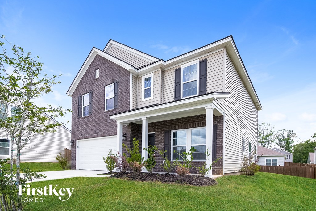 a brick house with a lawn in front of it