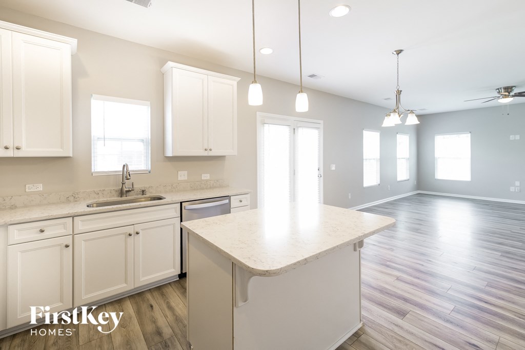 a kitchen with white cabinets and a white counter top